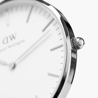 Close-up of Daniel Wellington men's watch with a stainless steel silver case, white dial, and resistant to scratches